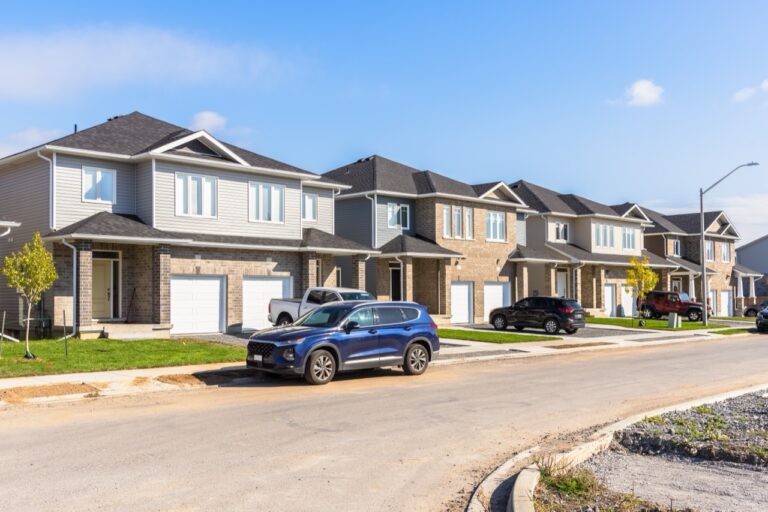 New semi-detached houses along a street in a housing development on a clear autumn day