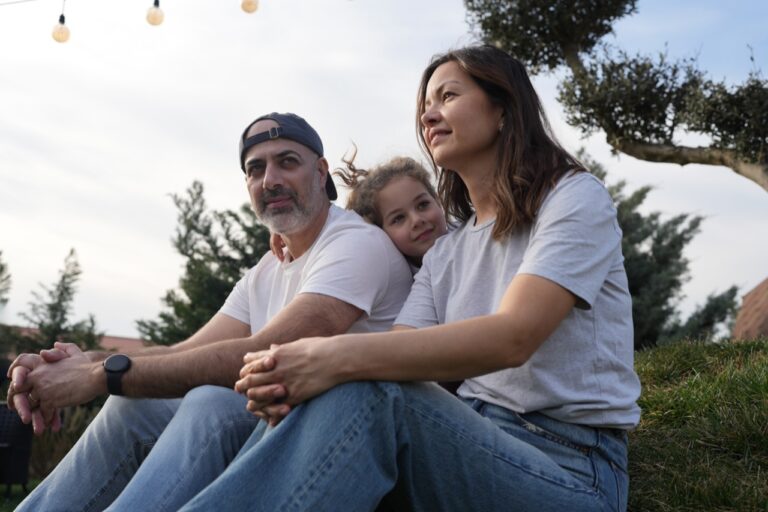 Parent-child moment in front of a home