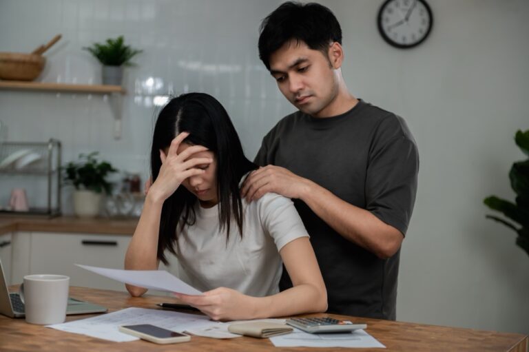 distressed couple at kitchen table