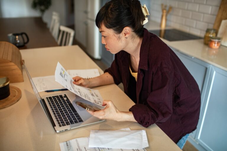Homeowner Reviewing Paperwork at a Kitchen Table